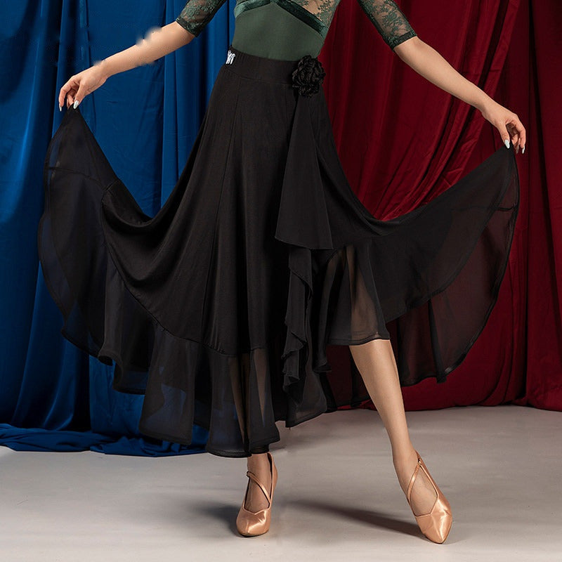 Black ballroom dance skirt with side rosette sash and asymmetric ruffle, hip and hem view