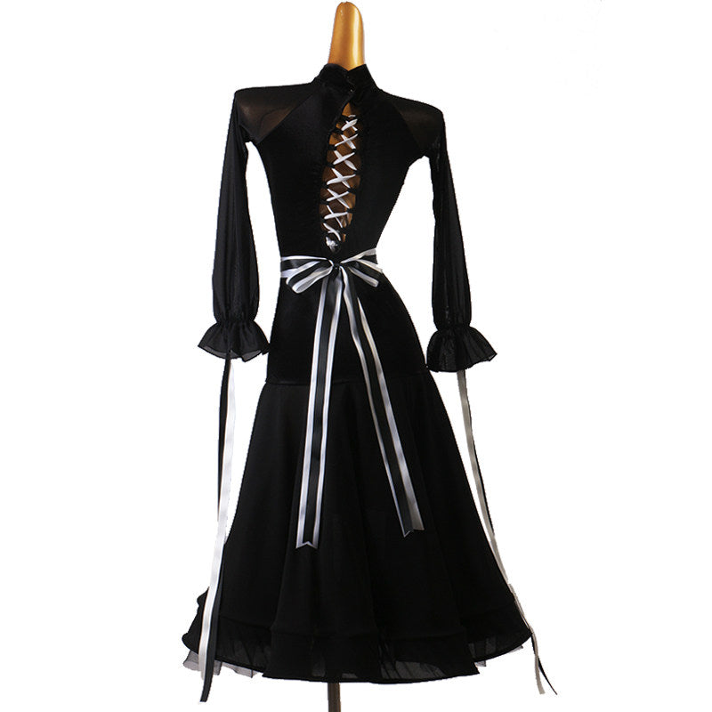 Back of the black ballroom dress with the ribbon ends falling past the hip