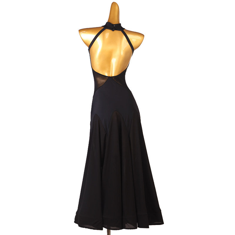 Back view of the black rosette dress showing the crossed neckband and open back
