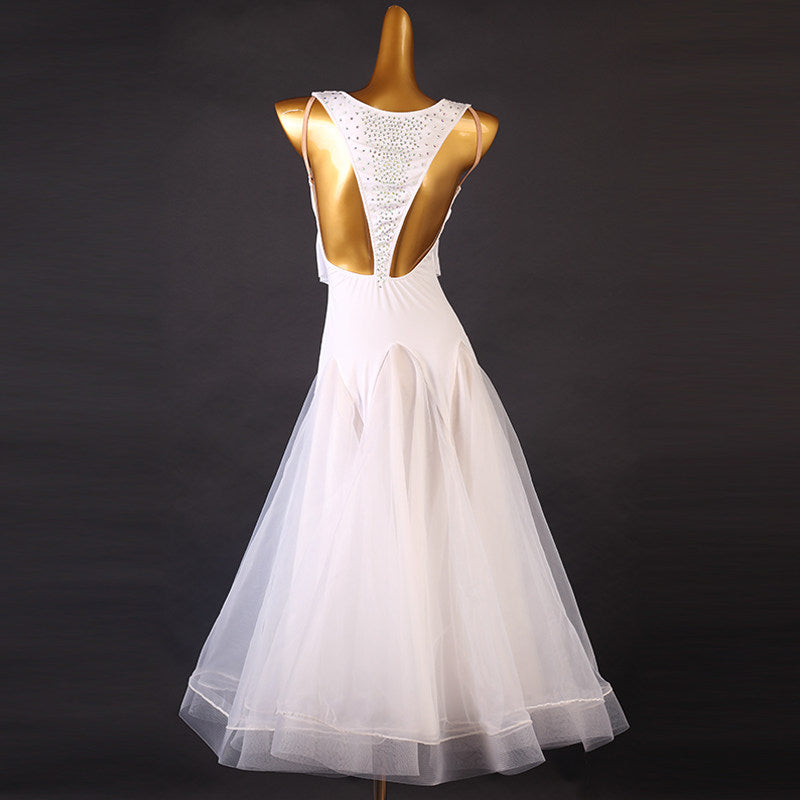 Back view of the white beaded empire waist dress showing the deep open back