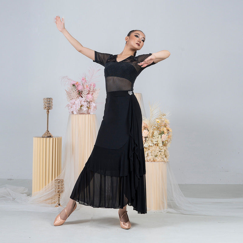Pleated mesh hem of the black ballroom practice skirt lifting through a turn