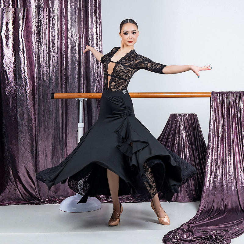 Black lace insert ballroom practice skirt flaring through a turn with pointed hem panels