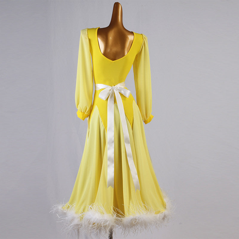 Back view of the yellow ballroom dress showing the satin bow and open scoop back