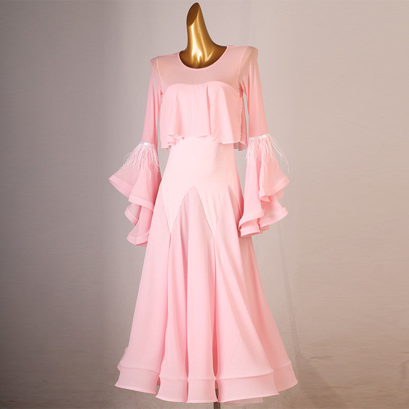 Pink practice dress with the tiered ruffle sleeves lifted to the side