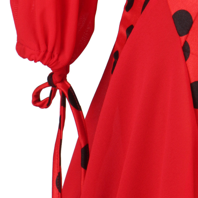 Close up of the ribbon tie cuff and black dot panel on the red ballroom dress