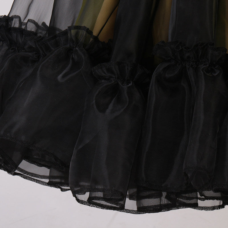 Close up of the gathered ruffle hem on the black mesh skirt