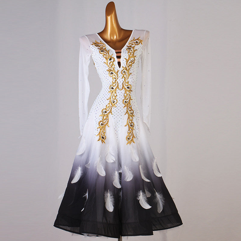 White ballroom competition dress with gold embroidery and black feather print hem