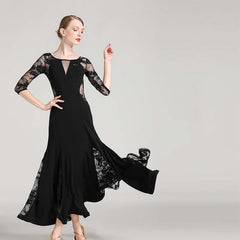 Dancer in a black ballroom practice dress with lace godets swinging out from the mermaid skirt