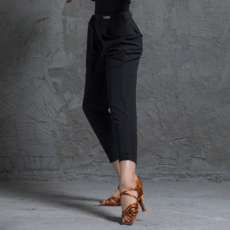 Black tapered Latin dance pants with button ankle cuffs, side view