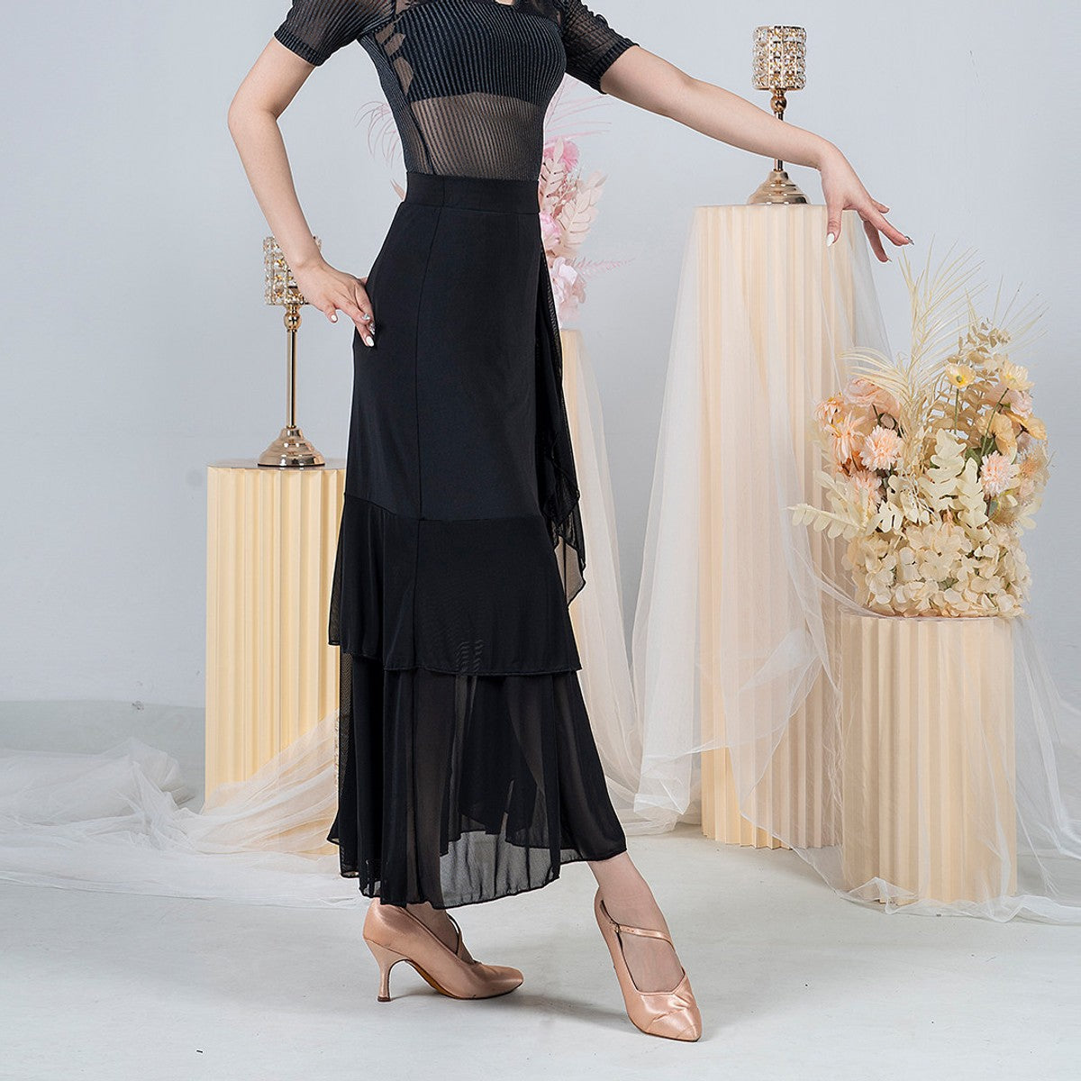 Black ballroom practice skirt with side wrap ruffle and sheer pleated mesh hem, front view