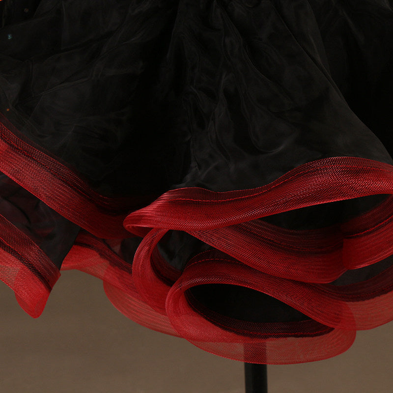 Close view of the red and black curled organza ruffle layers