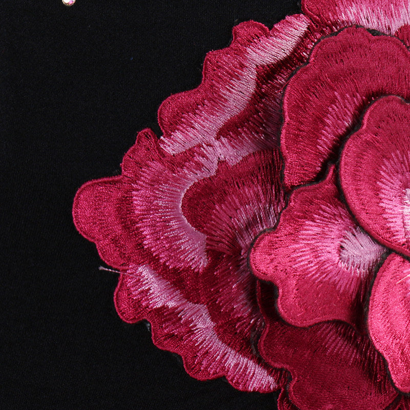 Close view of the layered fabric rose corsage
