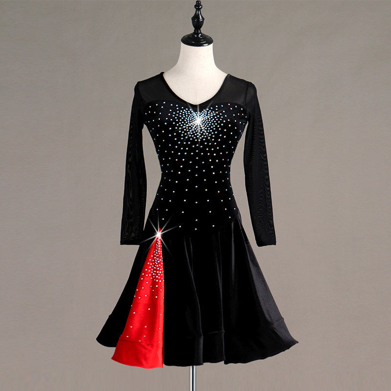 Black latin dance dress angled view with the red godet panel opening