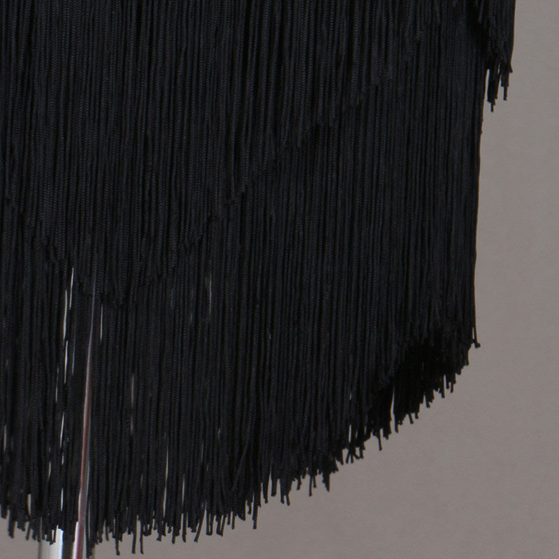 Close view of the dense black tassel fringe on the skirt