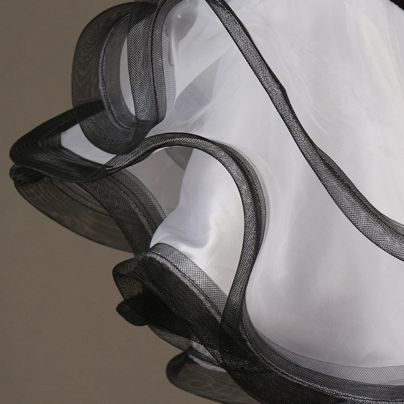 Close view of the white organza ruffle edged in black