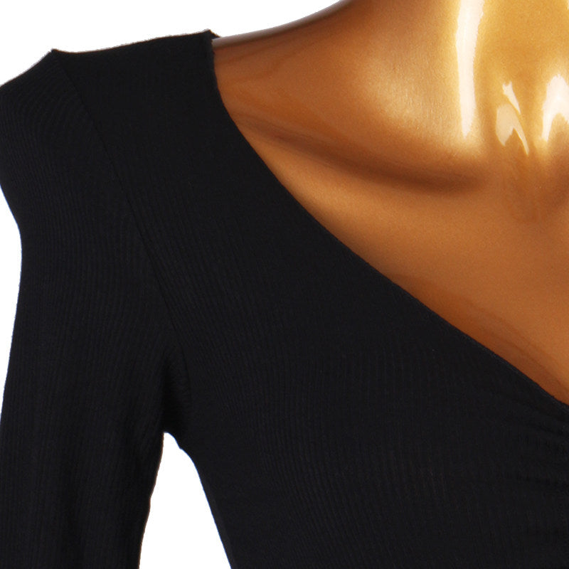 Close view of the shoulder seam and long sleeve on the ruched dress