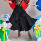 Black ballroom dance skirt with a front ruffle cascade and high yoke, hip and hem view