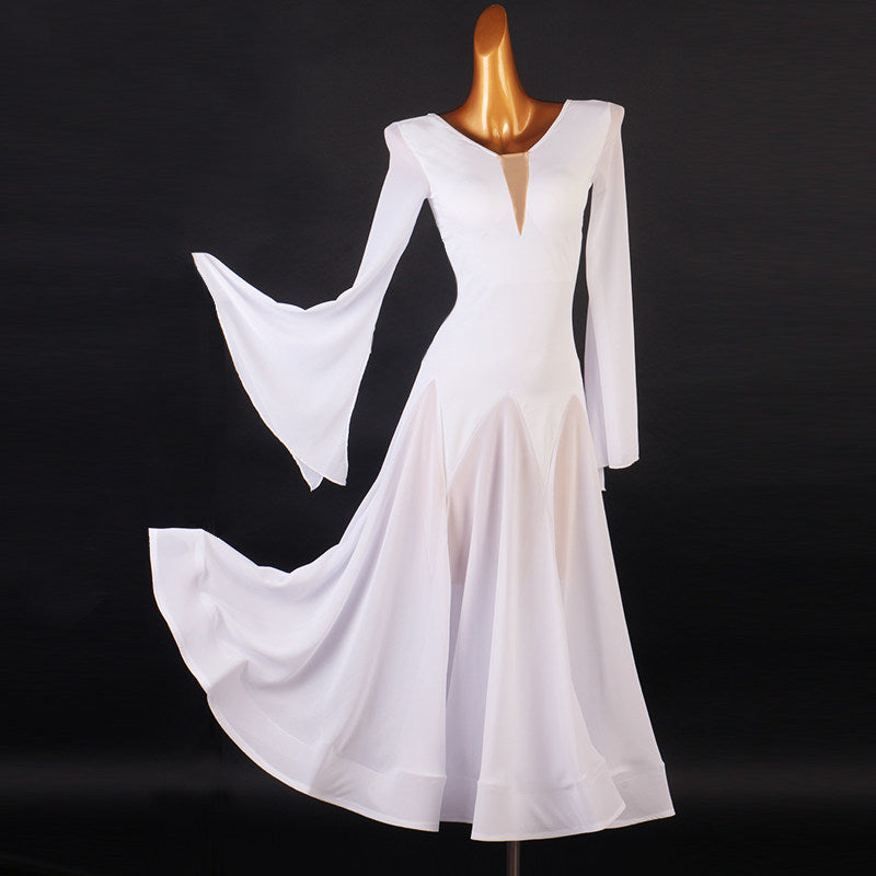 White ballroom dance dress with handkerchief flare sleeves lifted against a dark background