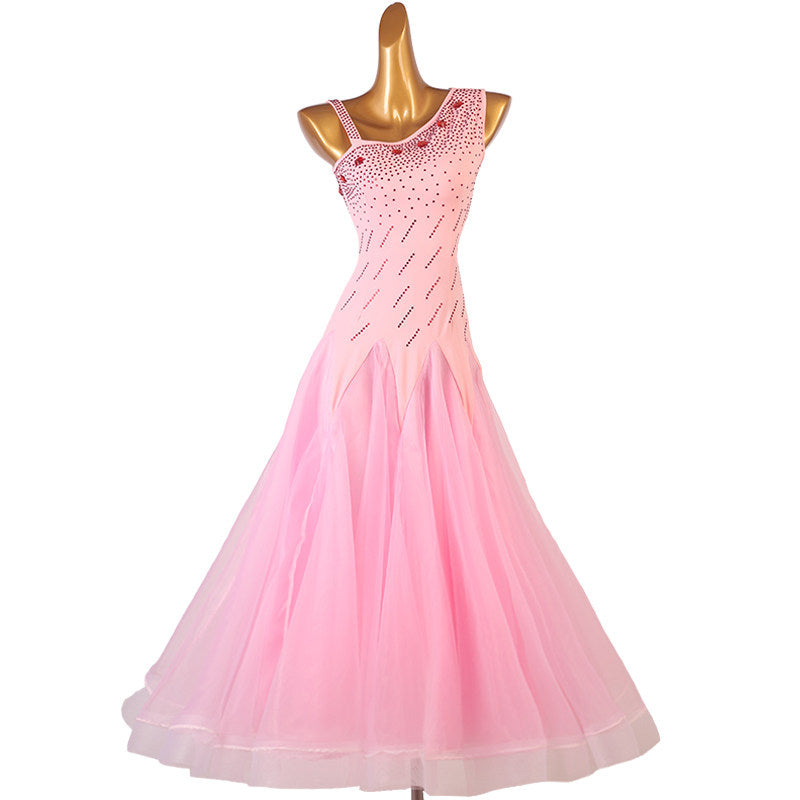 Pink ballroom competition dress with an asymmetric rhinestone bodice and tulle skirt