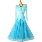 Turquoise ballroom competition dress with pearl lines and a crystal brooch