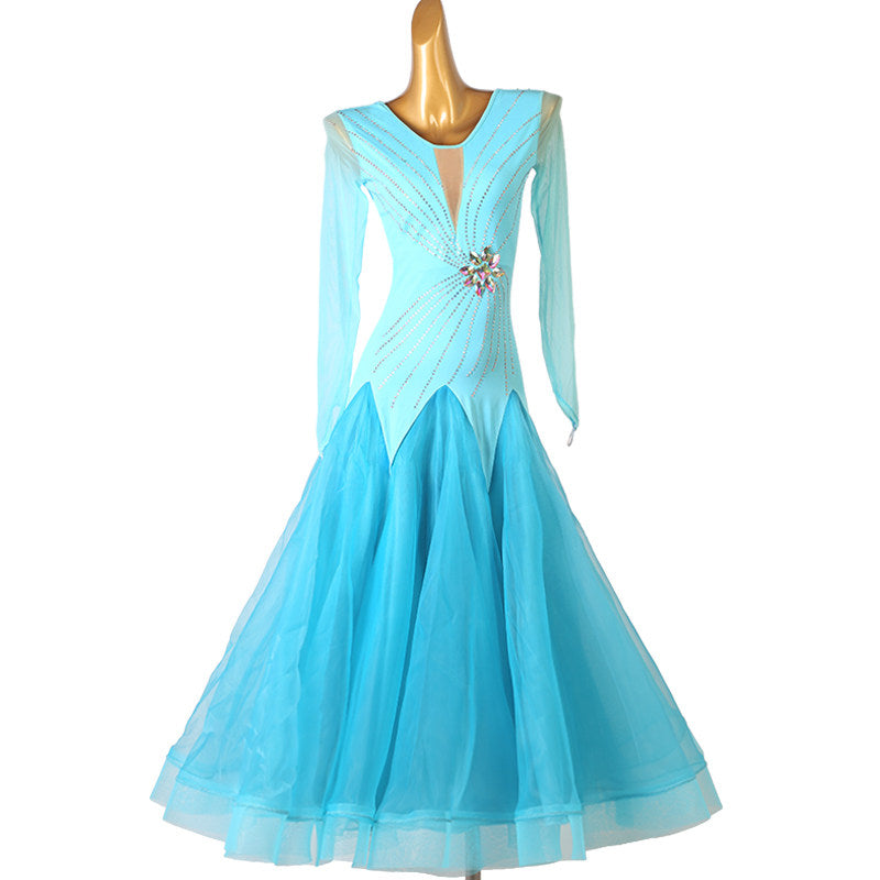 Turquoise ballroom competition dress with pearl lines and a crystal brooch
