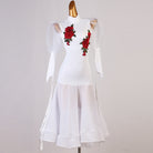 White ballroom dance dress with embroidered rose applique and mesh puff sleeves on mannequin