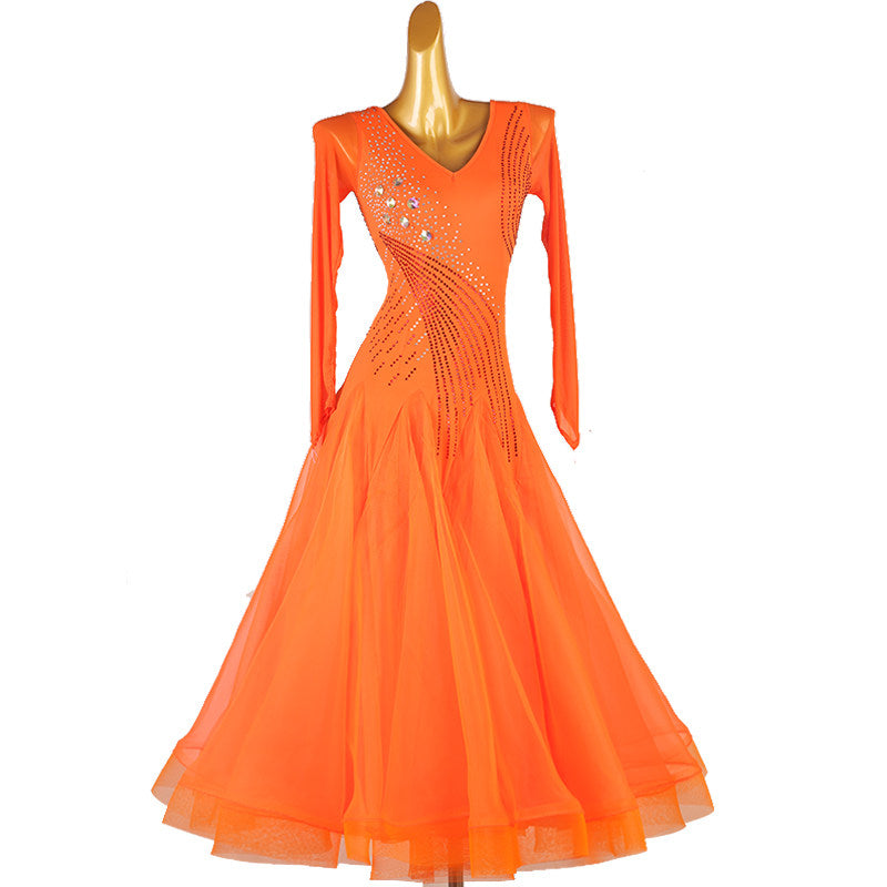 Orange ballroom competition dress with curved rhinestone lines and a tulle skirt