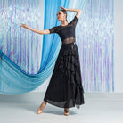 Diagonal ruffle tiers on the black ballroom practice skirt seen from the front