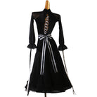 Back of the black ballroom dress with the ribbon ends falling past the hip