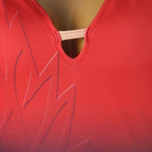 Close up of the keyhole at the point of the ruched red V neckline