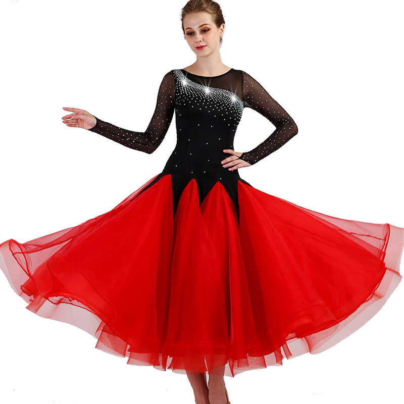 Black and red ballroom competition dress shown mid turn with skirt swept