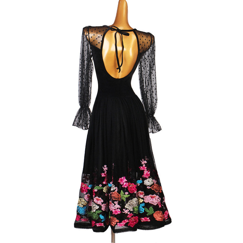 Black ballroom dance dress back view showing the open scooped back and embroidered border