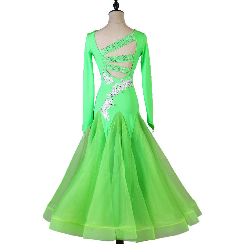 Back view of the green ballroom dress showing the crossed strappy open back
