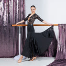 Black side ruffle cascade ballroom dance skirt held out to show the lace insert panel, full length view