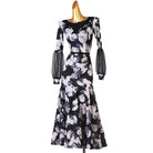 Black floral ballroom dance dress showing the mesh forearm sleeves