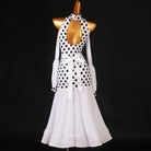 White polka dot ballroom dance dress with halter neck and lantern sleeves on dark background