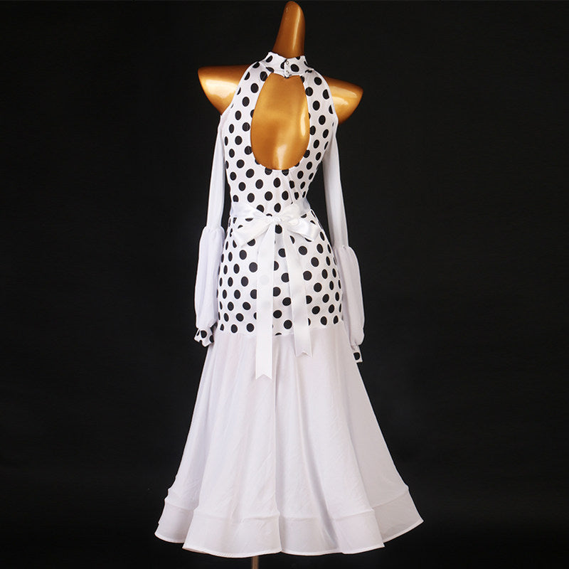 White polka dot ballroom dance dress with halter neck and lantern sleeves on dark background