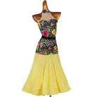 Floral print halter ballroom dance dress with a yellow flared skirt on mannequin
