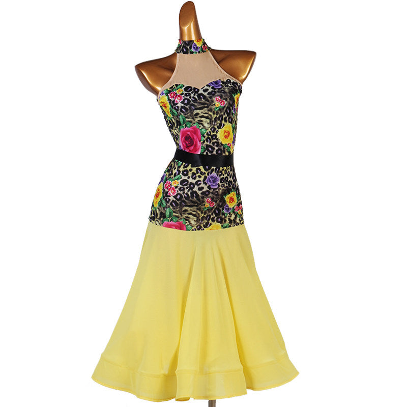 Floral print halter ballroom dance dress with a yellow flared skirt on mannequin