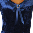 Close up of the satin bow and rhinestone buckle on the navy velvet bodice
