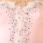 Close up of the ivory lace and rhinestones on the illusion yoke