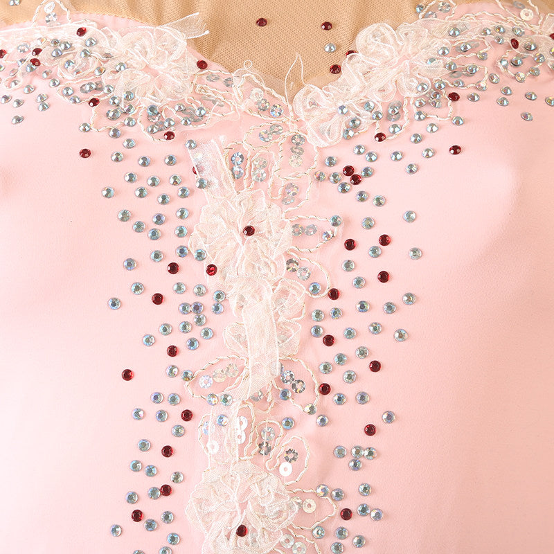 Close up of the ivory lace and rhinestones on the illusion yoke