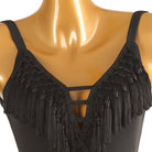 Close-up of the knotted tassel fringe and strappy caged V neckline