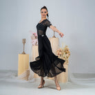 Close view of the layered wrap and mesh hem on the long black dance skirt
