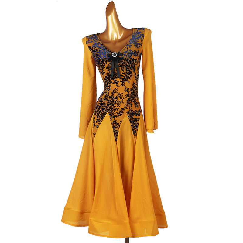 Front view of the golden ballroom dress showing the lace applique hip panels