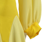 Close up of the pointed hip panel and lantern sleeve cuff on the yellow dress