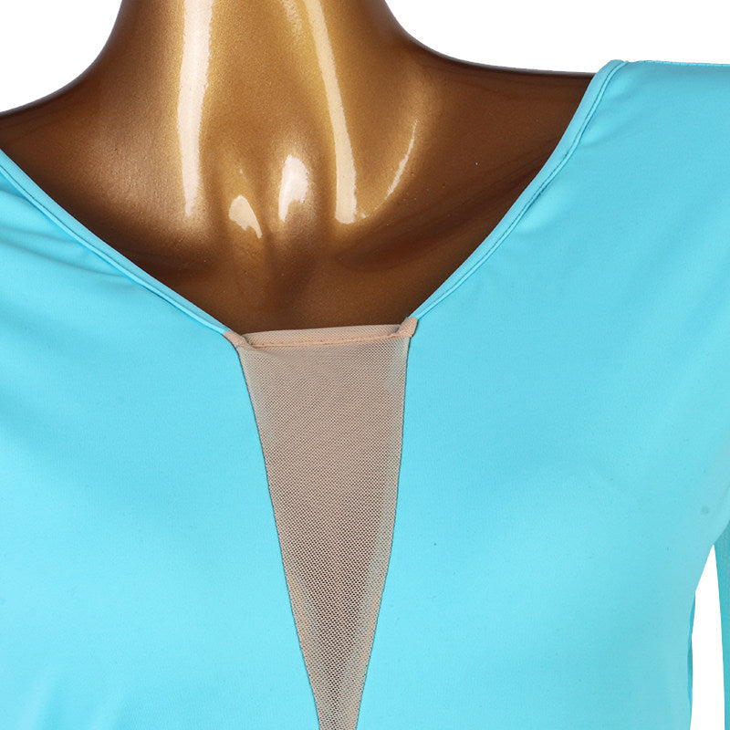 Close up of the nude mesh V insert at the neckline of the blue practice dress