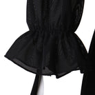 Detail of the short black mesh peplum over the layered skirt