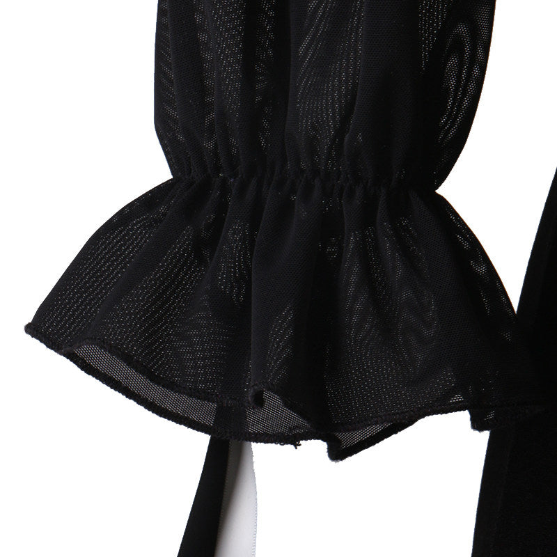 Detail of the short black mesh peplum over the layered skirt