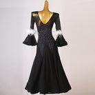 Black ballroom dance dress with scattered rhinestones across the bodice